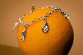 Bedelarmband met bedels, oester, krabbenpoot met edelsteentje en ijshoorn met parel