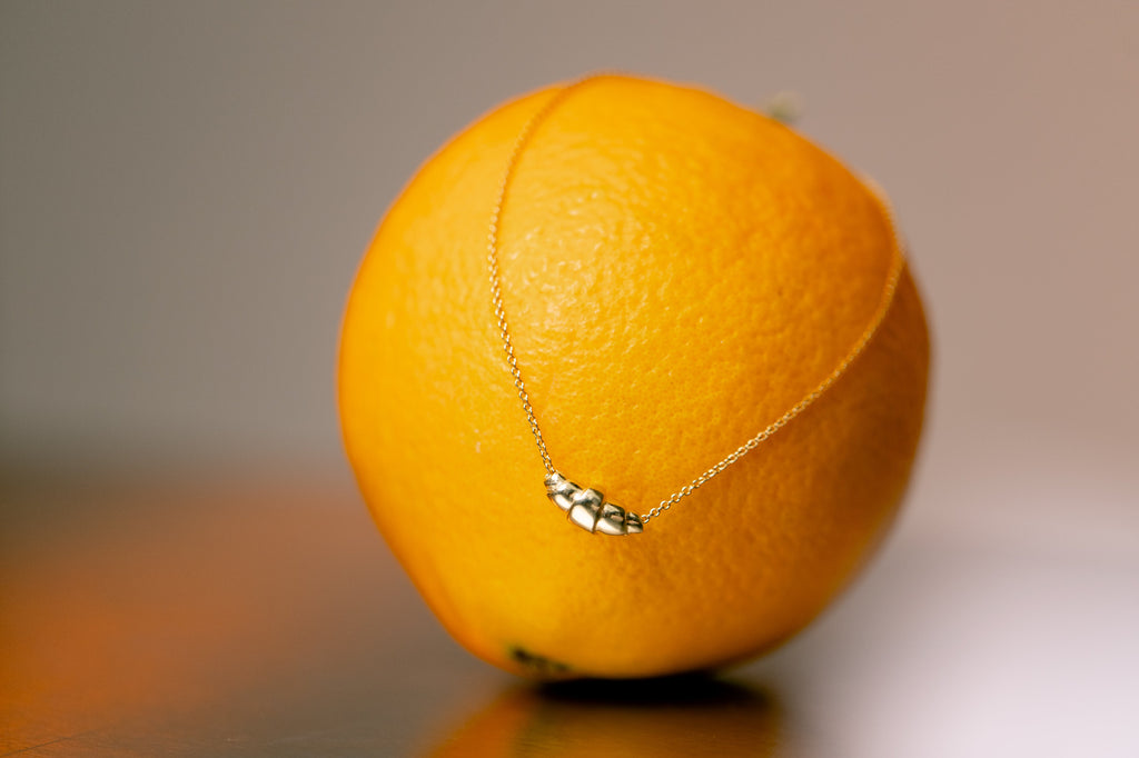 Close-up of Golden croissant on delicate chain. 